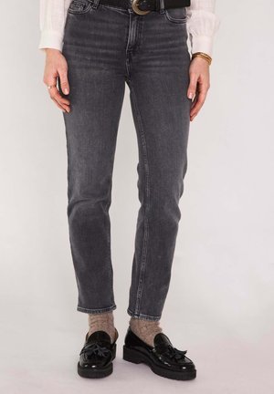 Gray denim jeans with a fitted design, featuring a mid-rise waist and subtle stitching details. Paired with black loafers and beige socks.