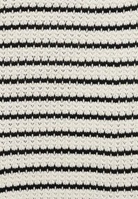 Knitted fabric featuring alternating stripes of white and black with a textured, open stitch pattern. Accents create visual depth.