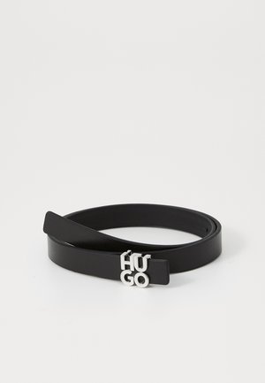 Black leather belt with a smooth texture, featuring a silver metal buckle displaying the letters "HUGO" in a modern font.