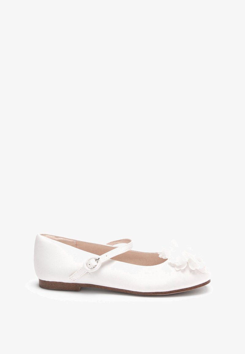 Chaussure plate blanche pour fille avec une bride unique et une boucle, ornée d'une fleur blanche décorative sur l'orteil arrondi.