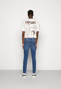 Diesel SLEENKER - Calças de ganga de corte skinny - 09d44 01