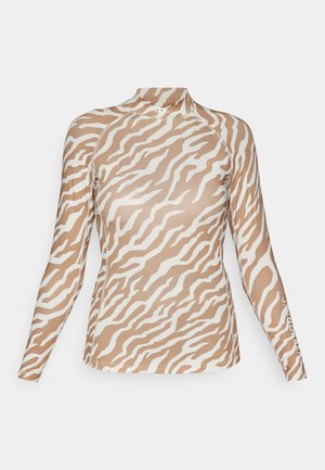 Long-sleeve top in a beige and white zebra stripe pattern, featuring a high collar and sleek, smooth texture. Logo on the sleeve.