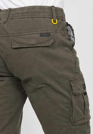 Olivenfarvede cargo bukser lavet af bomuld. Har en elastisk talje, sidelommer og en lappelomme på låret. Gul hardware detalje.
