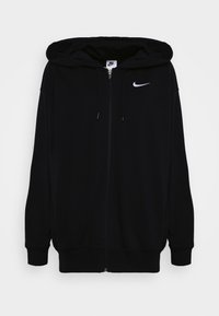 Svart zip-up hoodie gjord av mjukt tyg, med en rymlig huva, ribbade ärmslut och en vit Nike-logotyp på övre vänstra sidan.