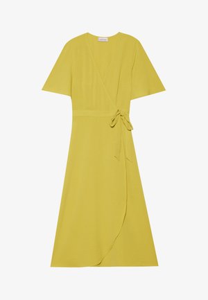 Yellow wrap dress with short sleeves, tie belt at the waist, and flowy hemline. Made from a soft, textured fabric.