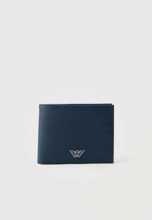 Navy blue wallet in textured faux leather with a bi-fold design, featuring a silver emblem on the front. Simple and sleek appearance.