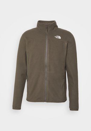 Chaqueta de forro polar verde oliva con un cuello alto, cierre frontal y dos bolsillos laterales. Presenta un pequeño logo blanco en la parte superior izquierda del pecho.