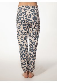 Beige joggings met luipaardprint met donkerblauwe en blosserige vlekken, elastische tailleband en strakke boorden. Geen zichtbare zakken.