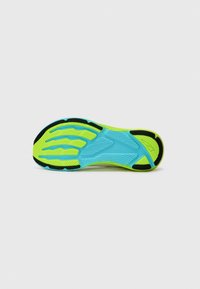 Semelle de chaussure arborant un design bleu vibrant et vert néon, surface texturée avec des rainures pour l'adhérence et éléments en caoutchouc noir.