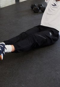 Reebok Teplákové kalhoty - black