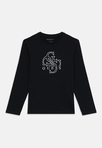 Black long-sleeve shirt with white overlapping G, U, E, S, S letters centered on front and "GUESS" text below the graphic.