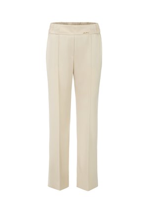 Beige, fitted trousers with a smooth texture and elastic waistband. Pleats down the front and a small gold accent on the waistband.