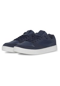 Navy blue sneakers with textured synthetic material, featuring horizontal ridges, mesh accents, and white rubber soles. Lace-up design.
