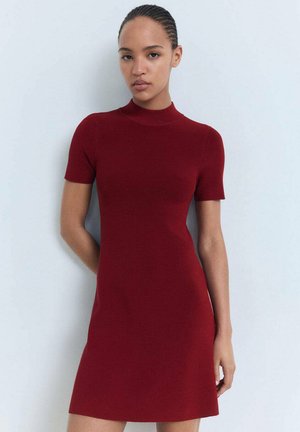 Ribbed knit dress in rich red, featuring a high neckline and short sleeves. Slim fit with a flared hem, smooth texture throughout.