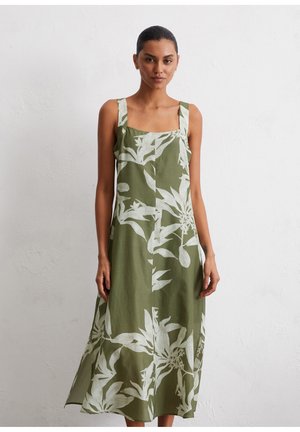 Grünes Leinenkleid mit weißem botanischen Druck, quadratischem Ausschnitt und breiten Trägern. A-linienförmiger Schnitt mit Länge bis zur Mitte der Wade. Leichter Stoff.