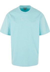 Light blue cotton t-shirt with a crew neck and short sleeves. Features a subtle white embroidered logo on the chest. Soft texture.