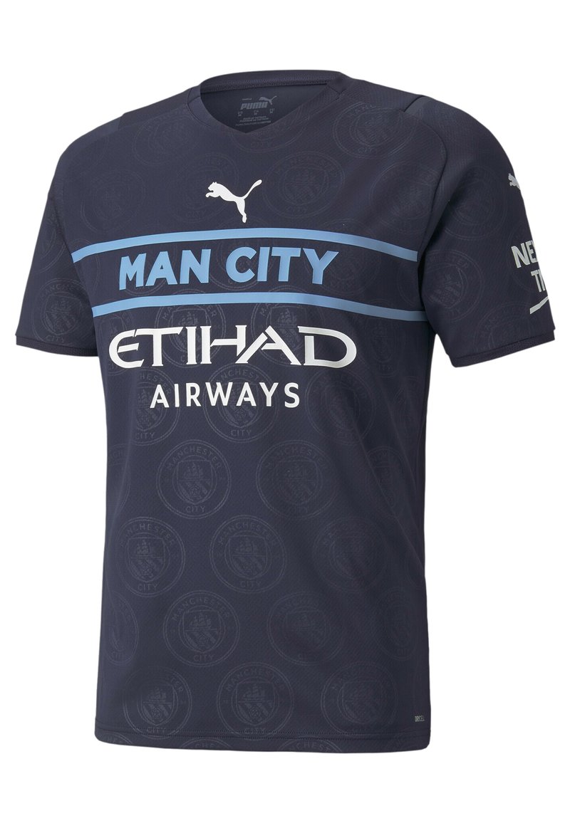 Tummansininen urheilu paita, joka on valmistettu kevyestä kankaasta ja jossa on pyöreä pääntie. Painetut logot: "MAN CITY" valkoisena, "ETIHAD AIRWAYS" valkoisena.