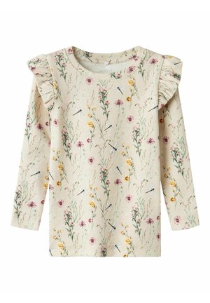 Beige langærmet skjorte med flæsedetaljer ved skuldrene, dekoreret med rosa og gule vilde blomster og små illustrationer af guldsmede.