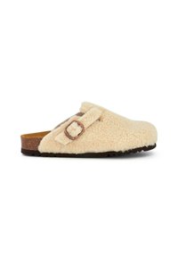 Fuzzy beige clogs made of soft material with a rounded toe, adjustable strap, and a cork sole for comfort and durability.