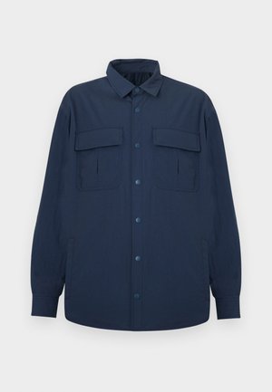 Navy blue button-up shirt jacket with long sleeves, two front flap pockets, and a collar, displayed on a flat light background.
