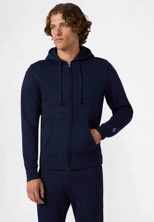 Dunkelblaue Zip-Hoodie aus Baumwollmischgewebe, mit verstellbaren Kordelzügen, zwei Vordertaschen und Logo-Akzenten auf der Brust und dem Ärmel.