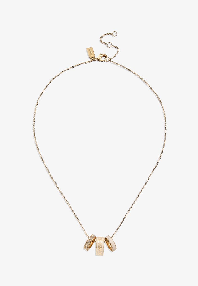 Guldtonet halskæde med en delikat kæde og tre runde vedhæng; to er prydet med rhinsten, mens den tredje har en glat overflade.