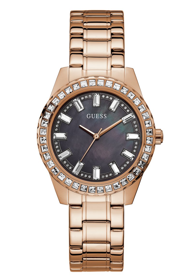 Montre en métal rose doré avec un cadran rond, un fond noir, des accents en cristal et des marqueurs d'heure audacieux. Dispose d'un design de bracelet à maillons.