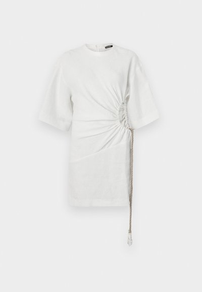 White linen shirt with short sleeves, featuring gathered sides and a drawstring detail at the hem for adjustable fit.
