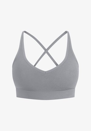 Brassière de sport grise avec un design en V, fines bretelles et dos croisé. Fabriquée en matériau doux avec une bande sans couture pour plus de confort.