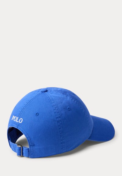 Casquette de baseball bleue avec sangle ajustable et texte blanc "POLO" brodé à l'arrière, présentée sur un fond clair uni.