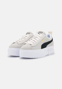 Sneakers in suede grigio chiaro con dettagli neri, suole piattaform unisex bianche e lacci tondi. Marchio sulla linguetta e sul lato.