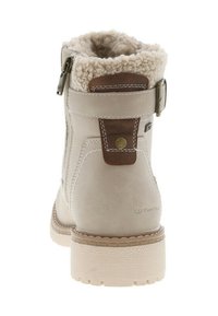 Bottines en suède beige avec bordure en shearling, fermeture éclair et accents en cuir marron. Semelle en caoutchouc texturé pour offrir une stabilité.