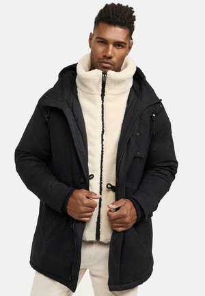 Black outer jacket with a textured finish, featuring a white fleece inner layer. Zipper and toggle closures, hood, and side pockets.