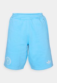 Blue sweat shorts with an elastic waistband, side pockets, and white logo detailing on the lower front and hem. Soft fabric texture.