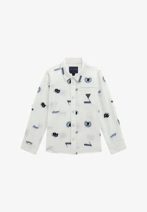 Camicia bianca a maniche lunghe con motivi ricamati blu, dotata di un davanti con bottoni, colletto e una piccola tasca sul petto lato sinistro.