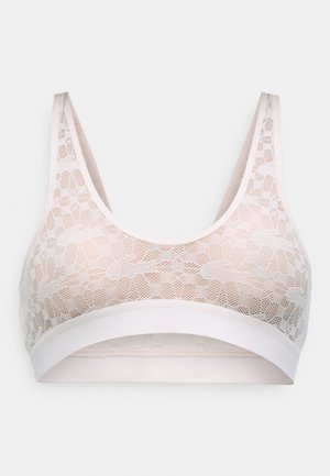 Bralette in pizzo di un rosa morbido con un motivo floreale e un'ampia fascia elastica. Presenta una scollatura a forma di U e un design a schiena scoperta.