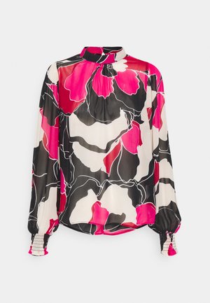 Blouse à manches longues avec col montant et poignets élastiques, avec un motif floral abstrait audacieux en rose, noir et blanc.