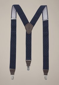 Granatowe szelki w białe kropki, z brązowymi skórzanymi wstawkami i srebrnymi klamrami. Tkanina o fakturze z diamentowym wzorem. Regulowany fason.