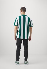 Puma AC MILAN CASUALS PANTS - Klub merchandise - black/for all time red