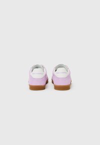 Purple suede sneakers featuring a white heel with logo, rubber sole, and cushioned lining. Simple, classic design suitable for casual wear.