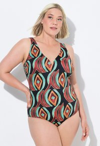 Maillot de bain une pièce avec une base noire et un motif géométrique en rouge, orange, teal et crème. Conception à col en V et larges bretelles.