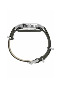 Boîtier de montre en acier inoxydable argenté avec un bracelet en silicone noir et une doublure intérieure beige clair. Présente une forme ronde et des éléments en métal.