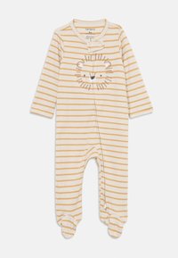 Stripet onepiece med gule og hvite striper, et løveansikt-design på brystet og trykknapp-lukking ved halsen. Laget av myk stoff.
