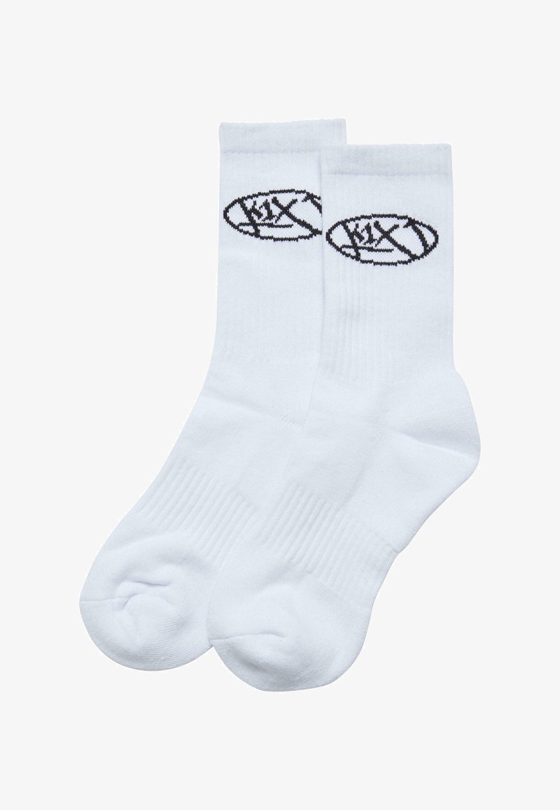Weiße Baumwollsocken mit einem schwarzen Logodesign. Die Socken haben einen gerippten Bund und eine verstärkte Zehenpartie. Klassischer sportlicher Stil.