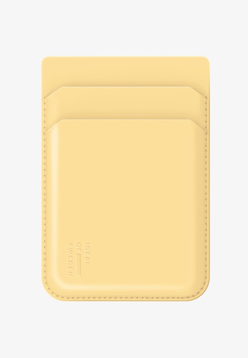 Slim beige leather cardholder with three slots and embossed "Ideal of Sweden" logo on the bottom left corner.