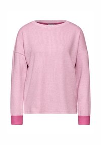 Felpa rosa con scollatura rotonda e maniche lunghe, leggermente oversize. I polsini sono di una tonalità di rosa più scura, realizzati in un morbido tessuto testurizzato.