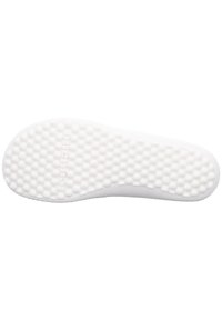 White shoe sole with a textured, dotted pattern. Features smooth edges and a slight curve, designed for grip and comfort.