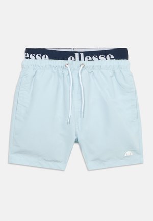 Hele sinine elastse vöökohaga ujumispüksid valge kinnituspaelaga, küljetaskutega ja tumesinise vööosaga, millelt on osa brändingust nähtav.