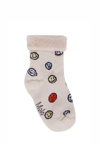 Beżowe skarpetki z frotowym ściągaczem, ozdobione kolorowymi wzorami uśmiechniętych buziek w żółtym, czerwonym, czarnym i niebieskim kolorze. Miękka, dziana struktura.