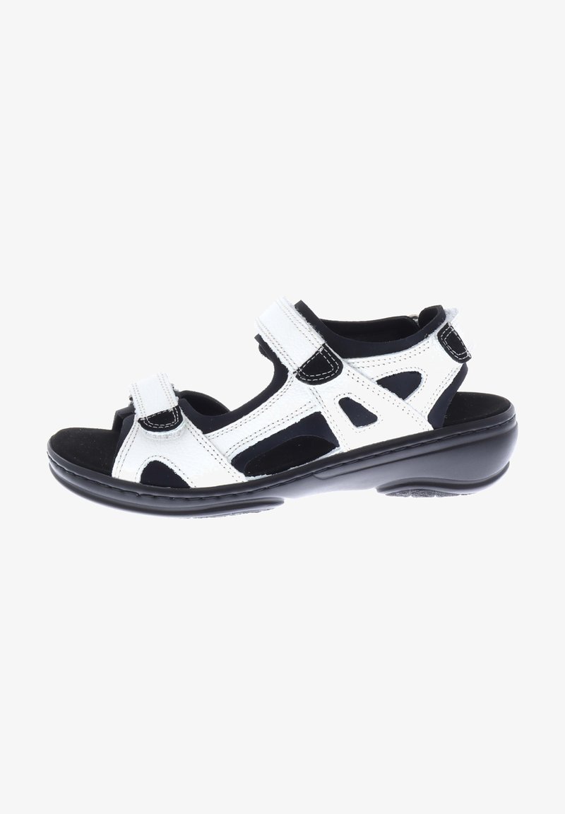 White leather sandal with black accents, adjustable hook-and-loop straps, open design, cushioned footbed, and a durable black sole.